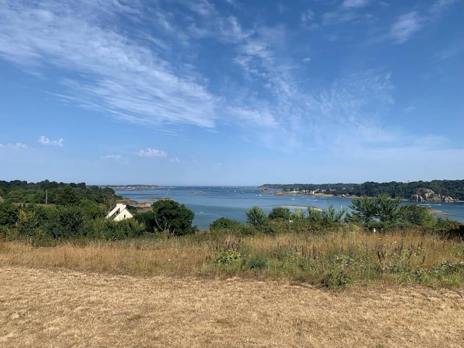 a house on a hill next to a body of water at Maison de Kermouster, juste avant le Paradis in Lézardrieux