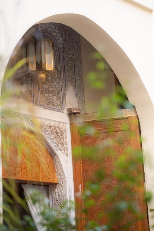 a close up of a door with a light on it at Riad Al Ansari in Fez