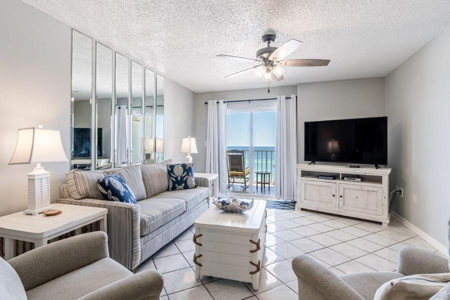 a living room with a couch and a tv at Ocean House 1605 in Gulf Shores