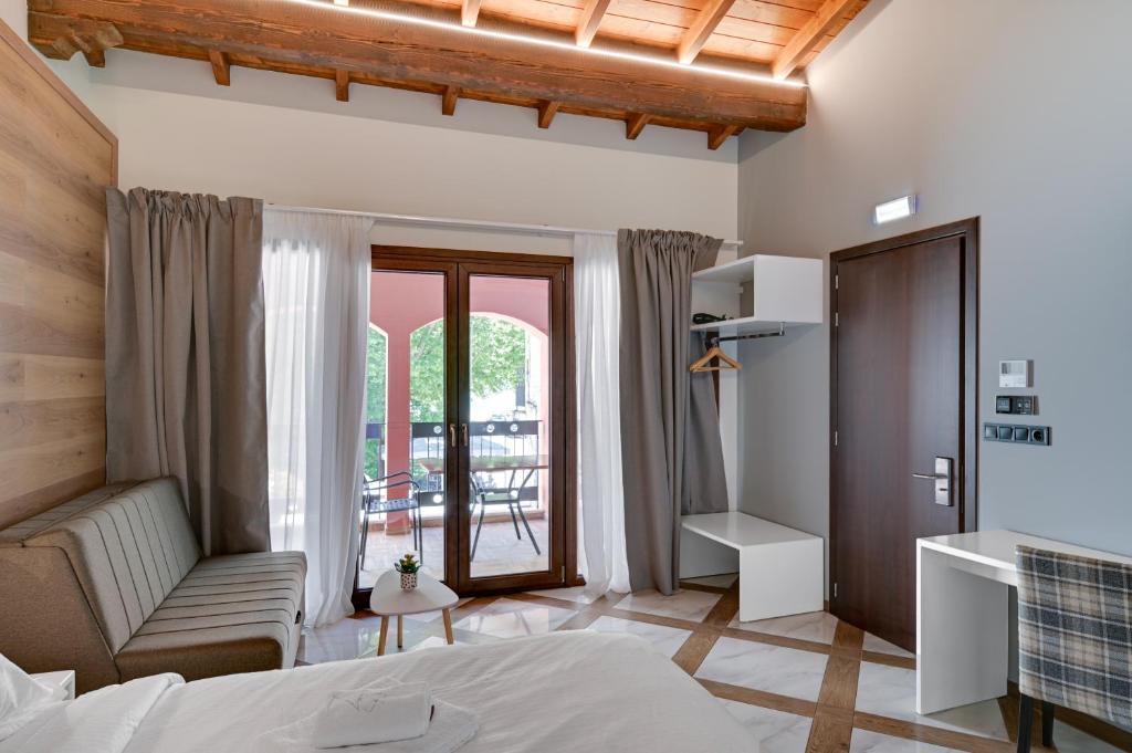 a hotel room with a bed and a balcony at Z Inn Ioannina in Ioannina
