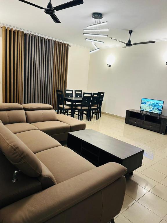 a living room with a couch and a table and chairs at Viveka Serviced Apartments in Nugegoda