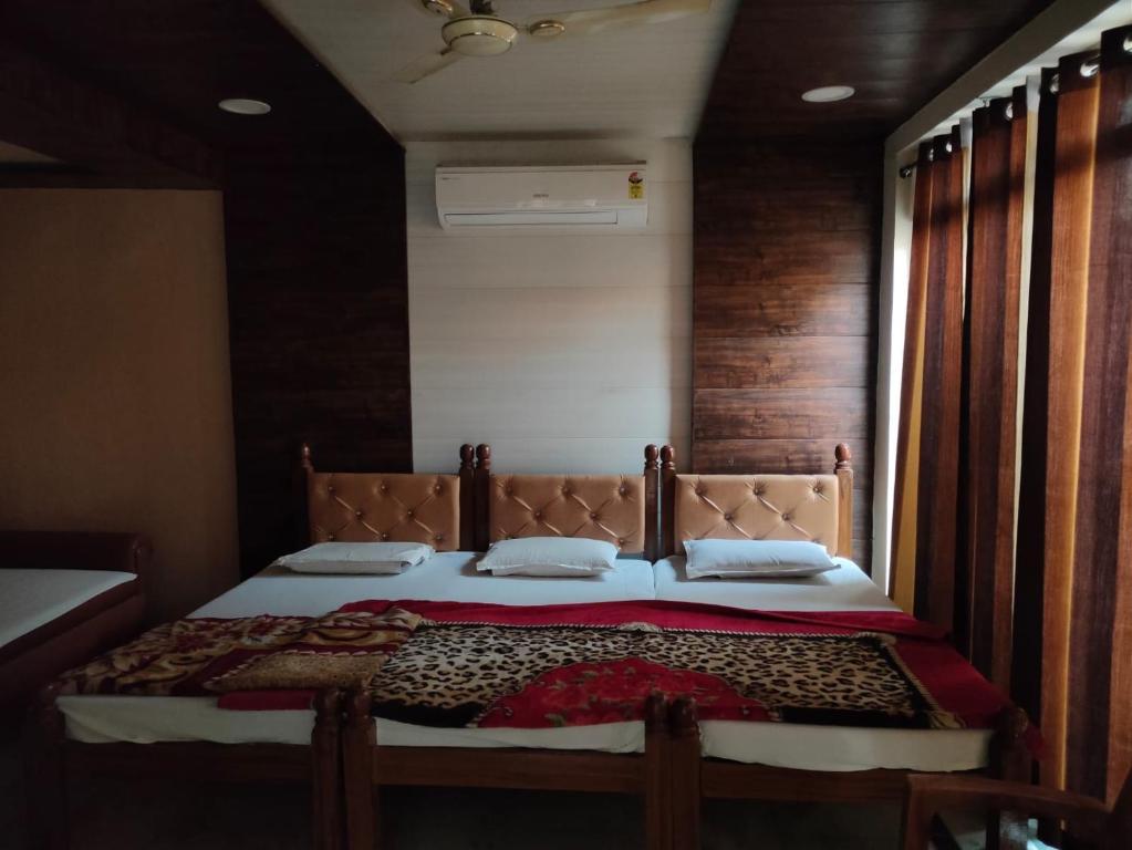 a bedroom with a large bed with a wooden wall at SGH Guest House in Mathura
