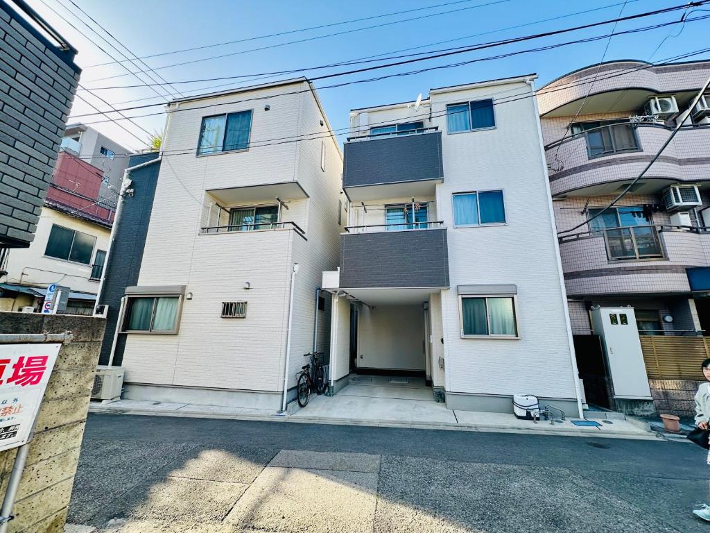 a large white building with a lot of windows at MoRi House IN西日暮里Ⅱ in Tokyo
