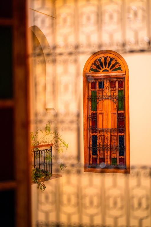 a stained glass door on the side of a building at Riad Al Ansari in Fez