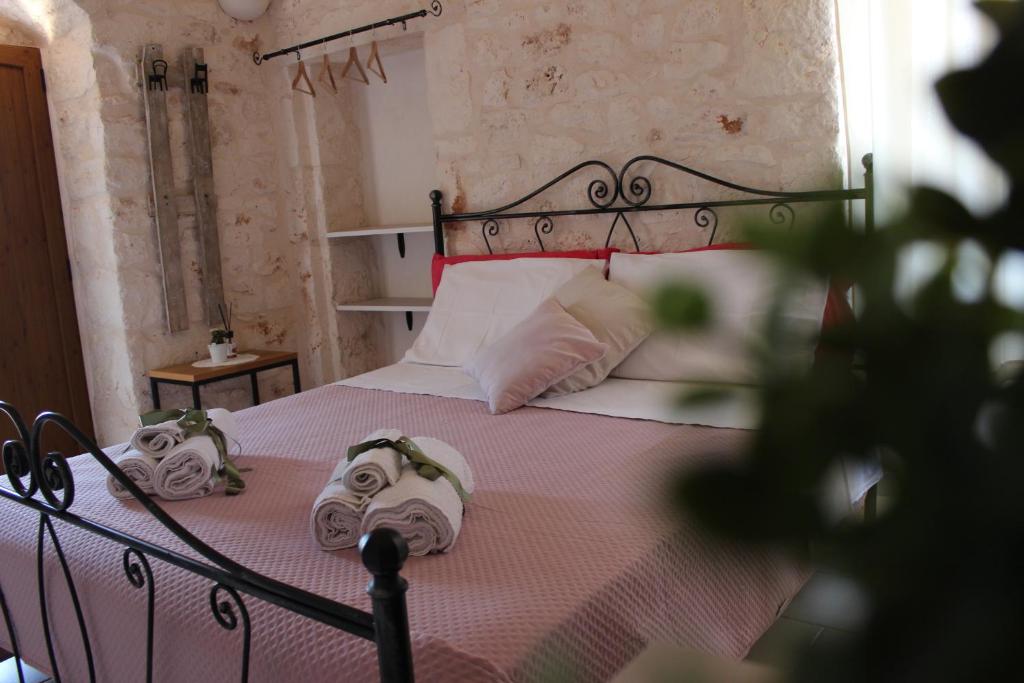 Postel nebo postele na pokoji v ubytování Il Trullo e la Pietra