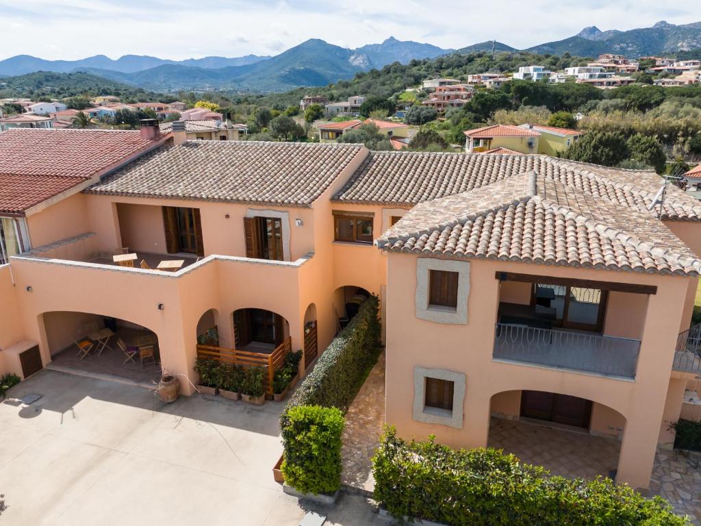 an aerial view of a house with mountains in the background at Acquarello Rooms in San Teodoro