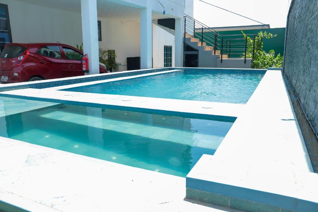 a swimming pool in front of a house at 5 Bedrooms Luxury Vacation Villa in Accra
