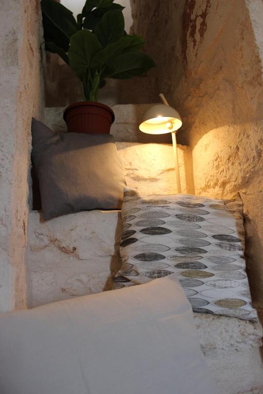 Postel nebo postele na pokoji v ubytování Il Trullo e la Pietra