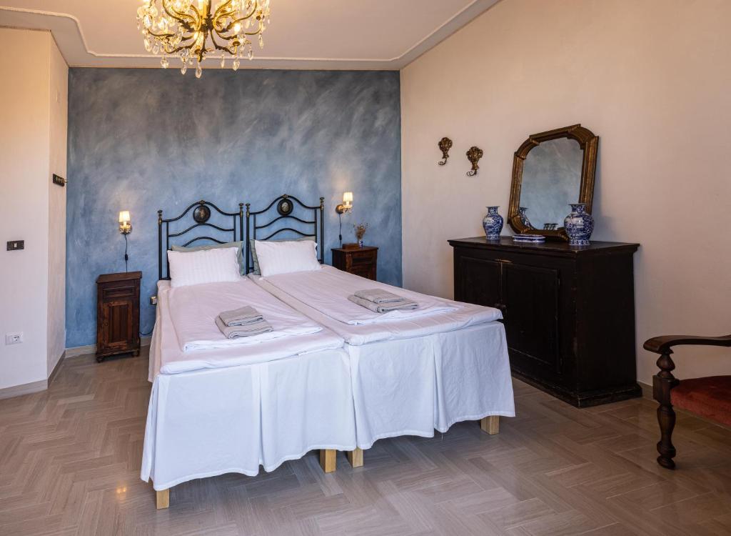 a bedroom with a large bed and a mirror at Casa Agello B&B in Ripatransone