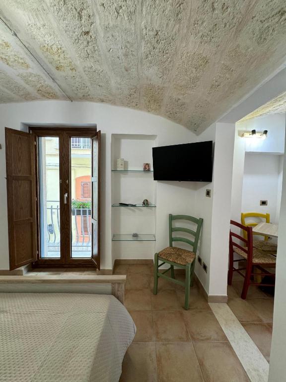 a bedroom with a bed and a tv on a ceiling at Le Casette di Ciccio in Fasano