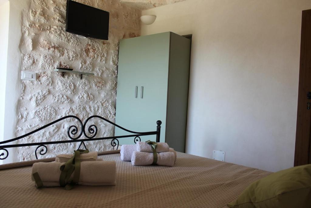 Postel nebo postele na pokoji v ubytování Il Trullo e la Pietra