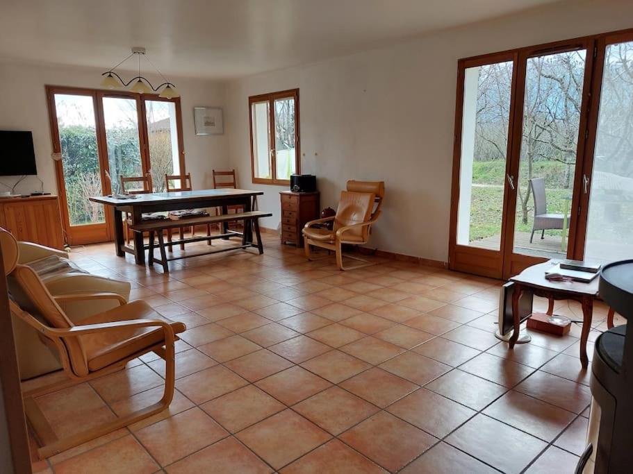 a living room with a ping pong table and chairs at Villa dans vaste jardin arboré in Aix-les-Bains