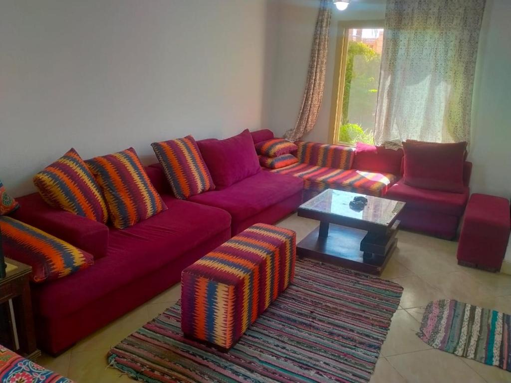 a living room with a purple couch and a table at العين السخنة in Ain Sokhna