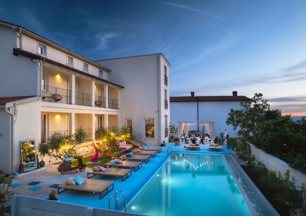 una piscina al aire libre con tumbonas y un hotel en Vinkuran Residence - Adults Only, en Pula