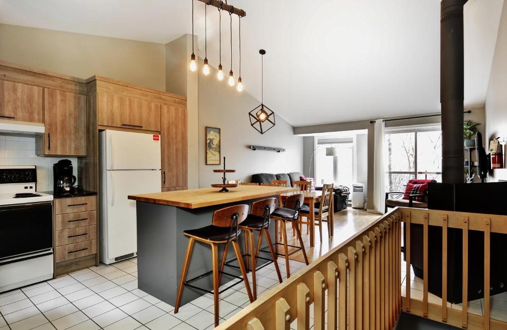 a kitchen with a counter and some chairs in it at 51 Chemin de la Corniche in Stoneham