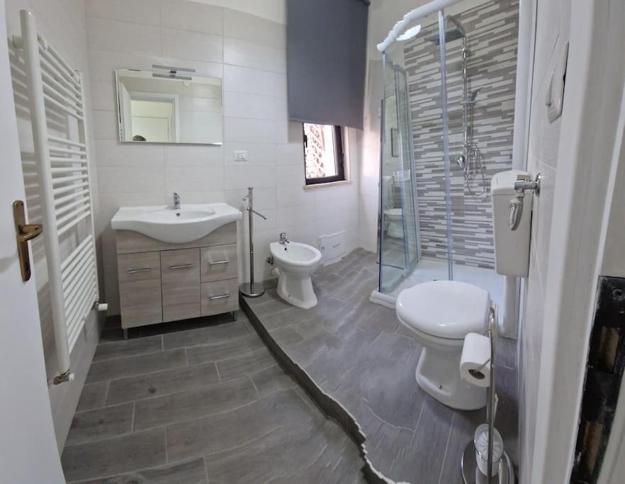 a bathroom with a sink and a toilet and a shower at LaCasAMare in Molfetta