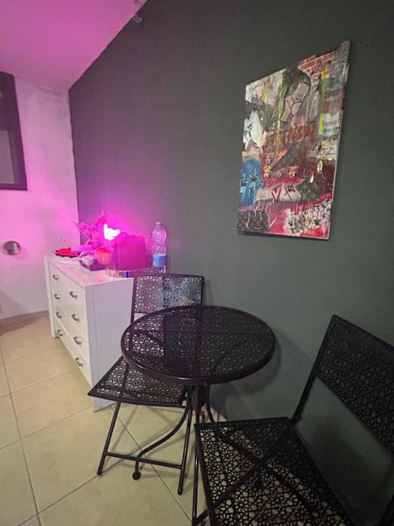 a room with a table and chairs and a desk at Roof top glamping and Toys suites in Eilat