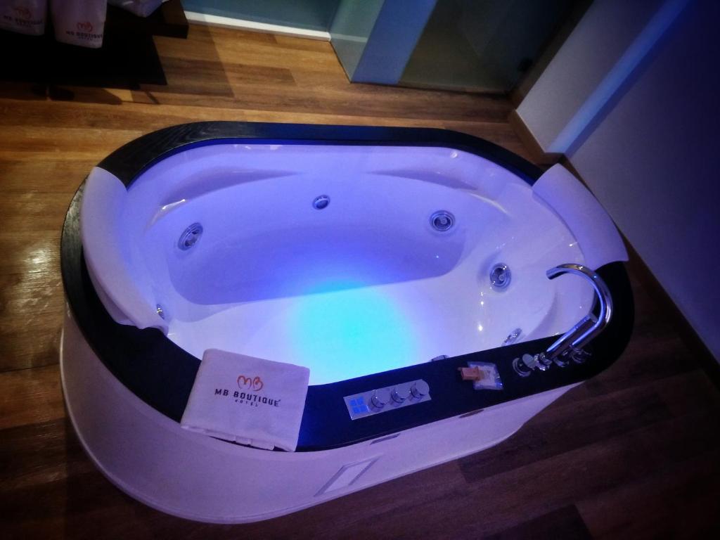 a white bath tub with a sign in it at MB Boutique Hotel - Adults Recommended in Nerja