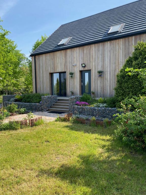 a wooden house with a garden in front of it at Zielnisko in Firlej