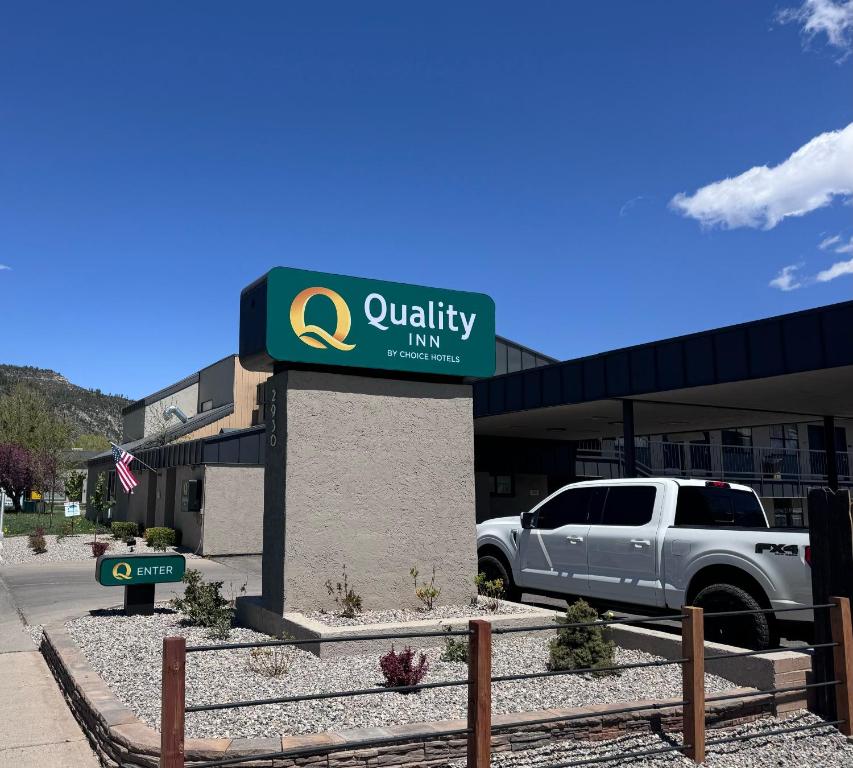 a car parked in front of a building with a sign at Quality Inn Durango in Durango