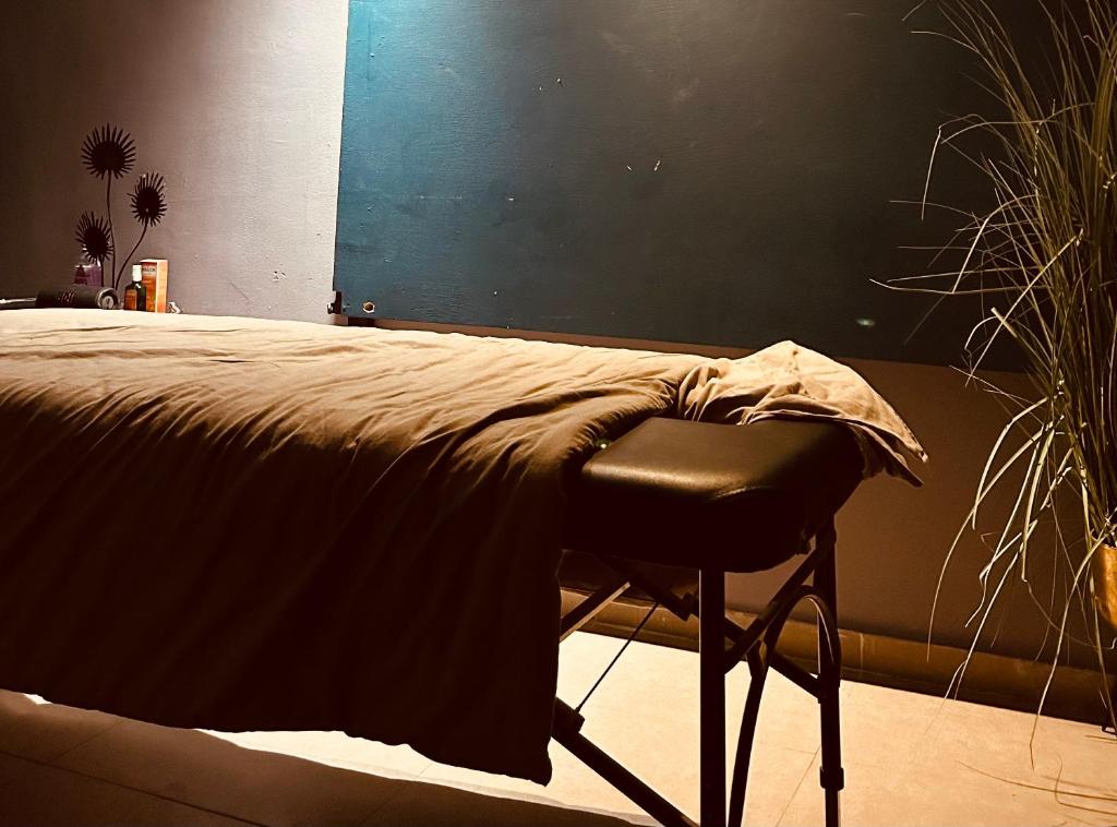 a bedroom with a bed with a chair in it at Roof top glamping and Toys suites in Eilat
