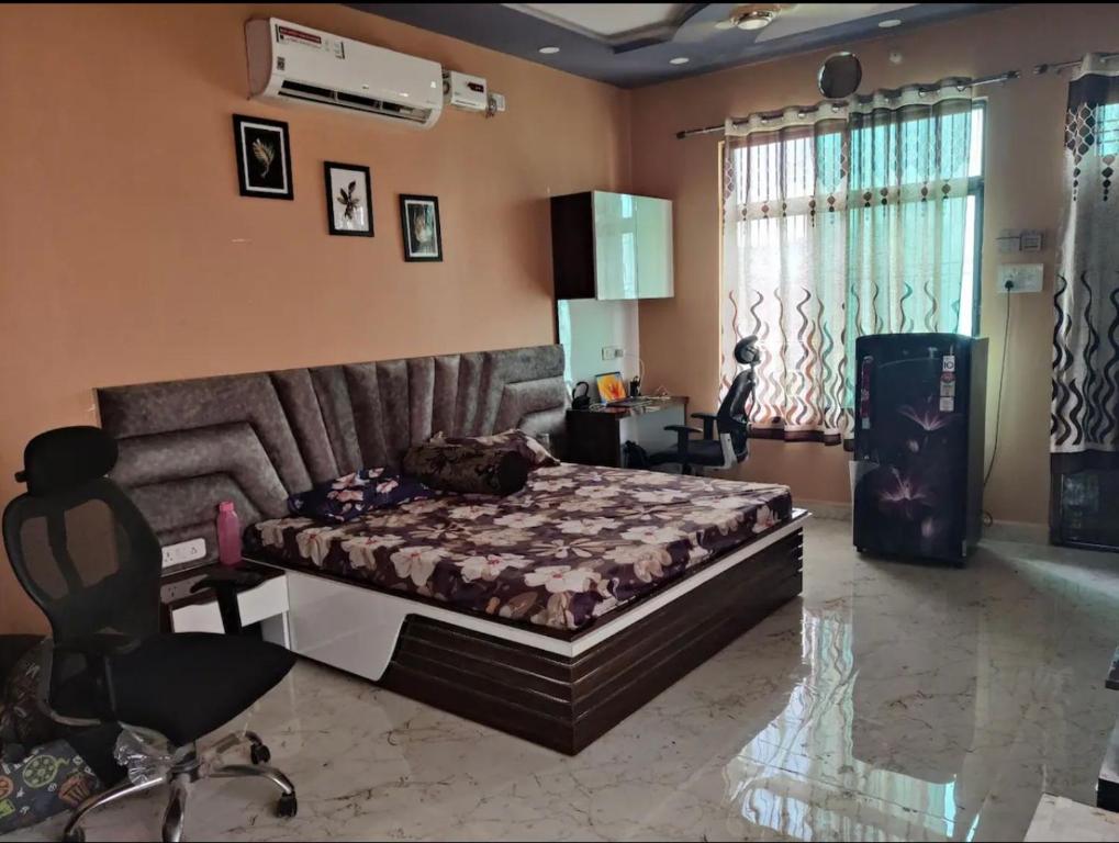 a bedroom with a bed and a desk and a chair at Your Own Sweet Nest in Gwalior with comfort in Gwalior