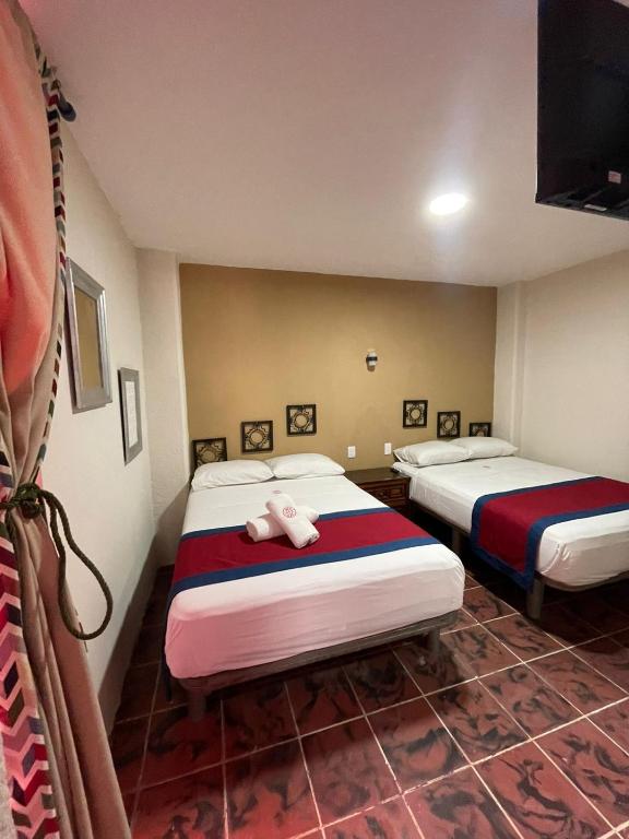 Postel nebo postele na pokoji v ubytování Hotel Flamingos