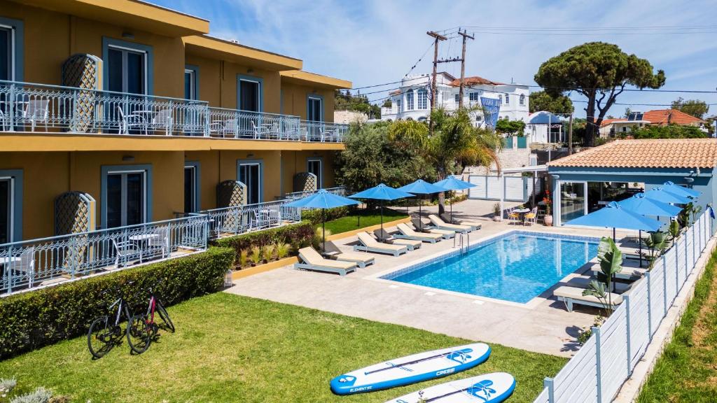a view of the pool at a hotel with chairs and umbrellas at Memories Apartments in Laganas