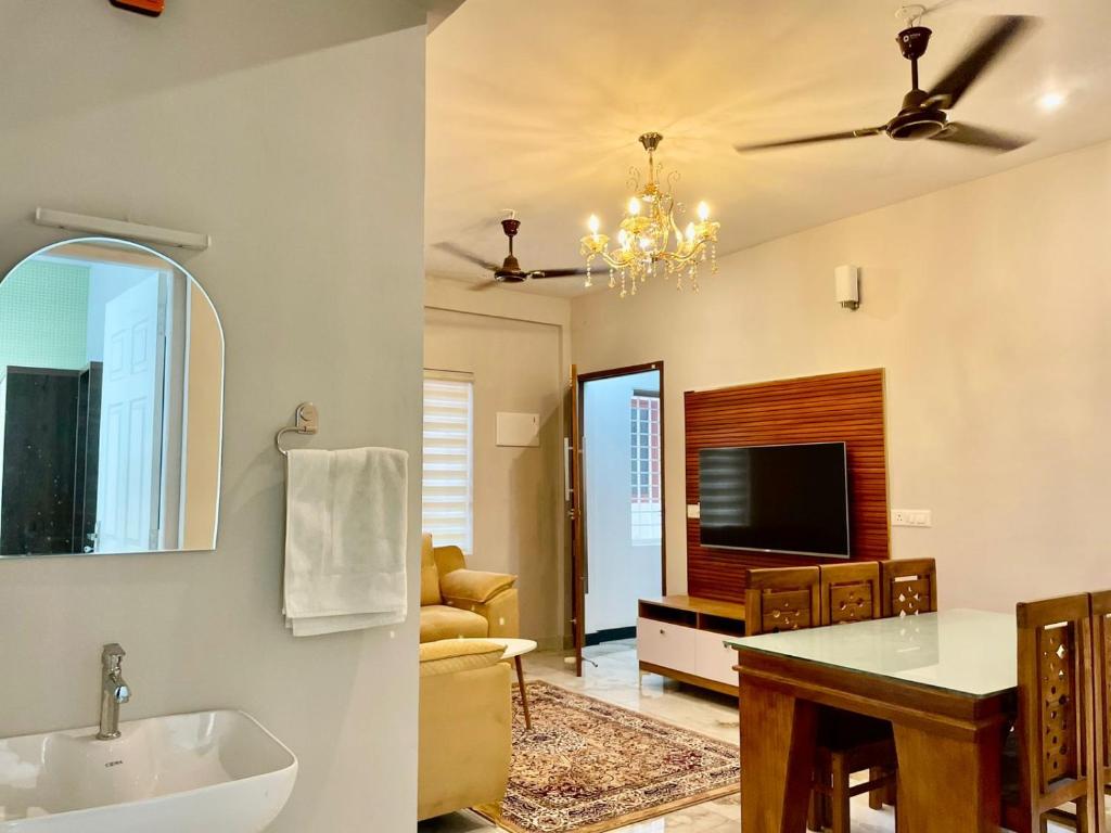 a bathroom with a sink and a living room at 88 homes kochi in Ernakulam