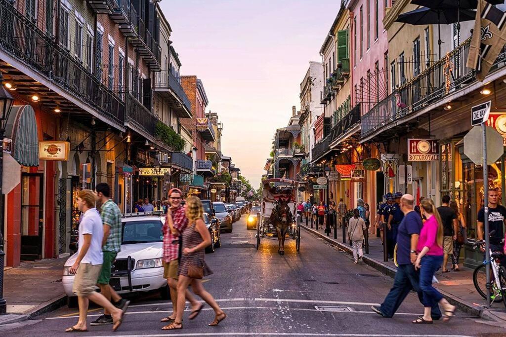 a group of people crossing a busy city street at Heart of the French Quarters in New Orleans