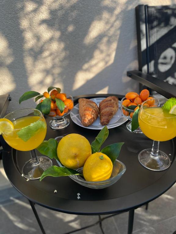 a table with plates of fruit and glasses of orange juice at Denis Apartment in Ždrelac