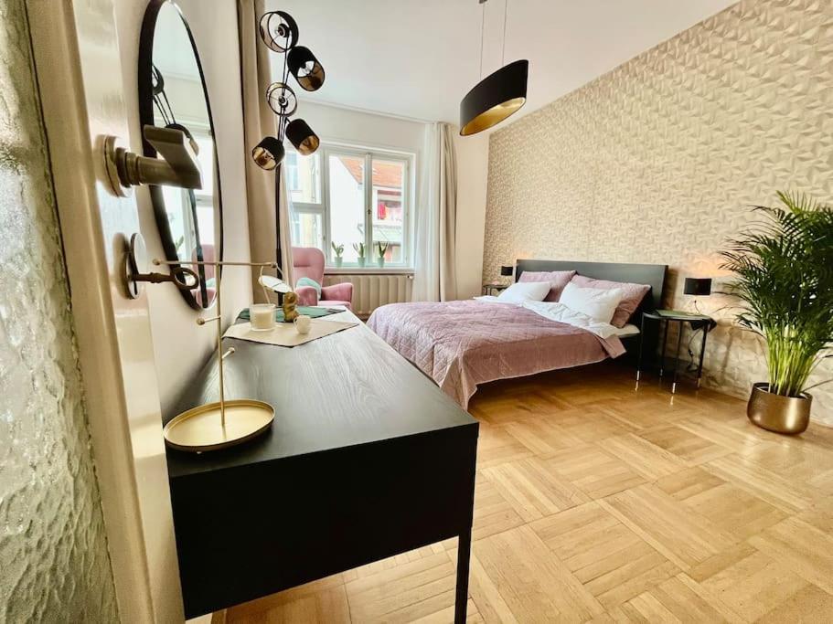a bedroom with a bed and a table with a mirror at Luxury Apartment in Old Town in Prague