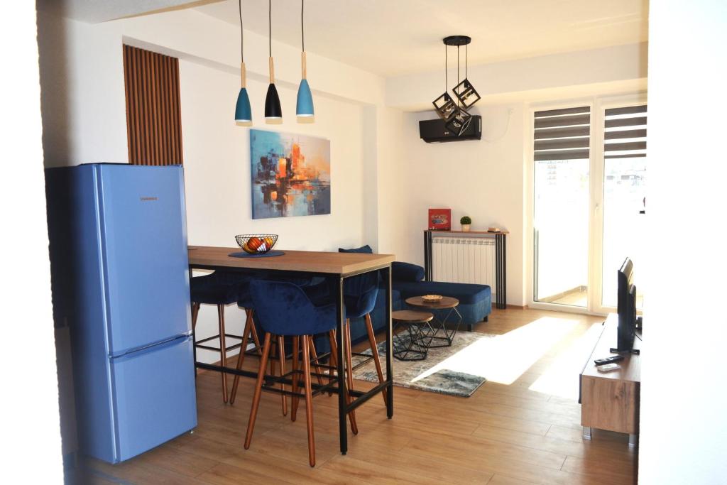 a kitchen and living room with a table and chairs at New apartment in Skopje Center - FREE Private Parking in Skopje