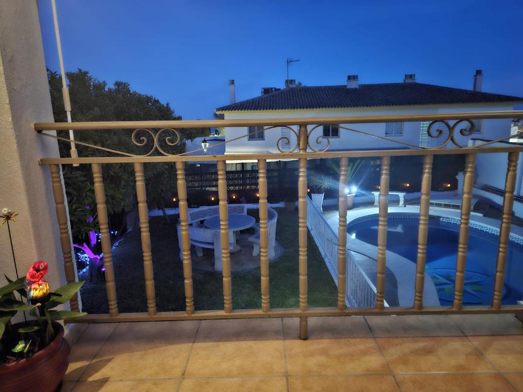 a balcony with a fence with a swimming pool at VILLA TONY in Benalmádena