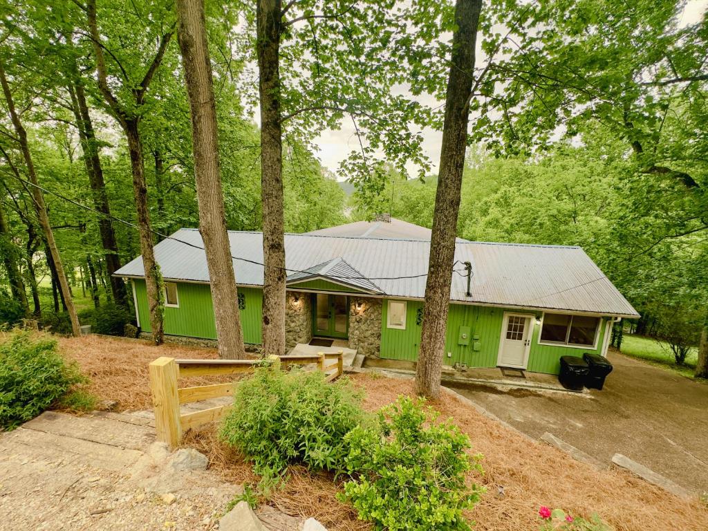a green house in the middle of a forest at CHLChateau-Walkable to Hurricane Marina in Silver Point