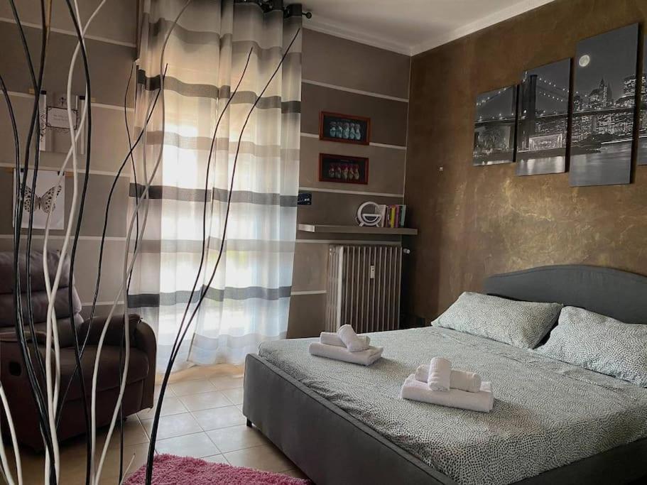 a bedroom with a bed with two towels on it at La Ramblé in Turin