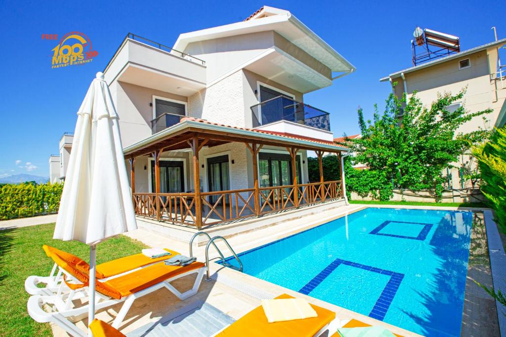 a villa with a swimming pool and a house at Paradise Town Villa Lisa in Belek