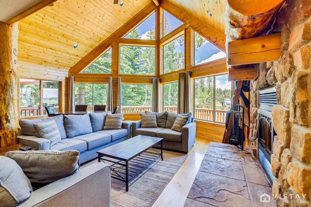 a living room with a couch and a table at Strawberry Valley Villa -Stunning Views w/ Firepit in Duck Creek Village