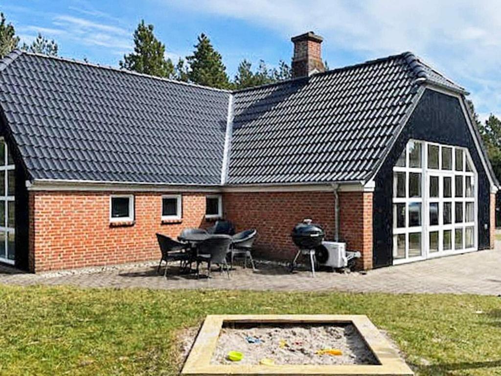 una casa de ladrillo con una parrilla delante de ella en 10 person holiday home in N rre Nebel, en Lønne Hede