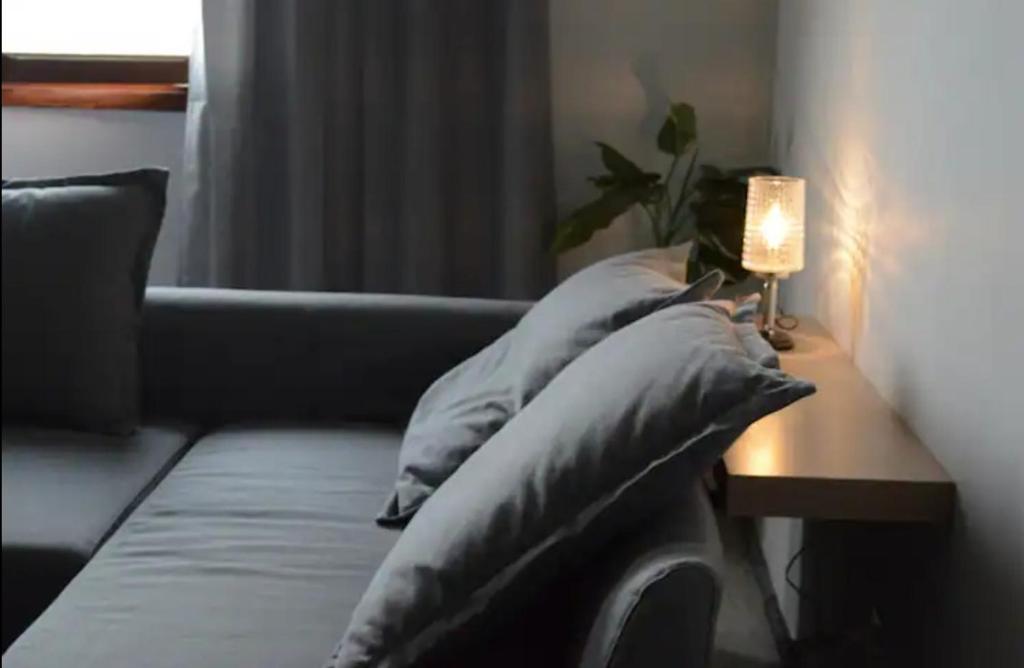 a living room with a couch and a table with pillows at Casa La Parra in Tejeda