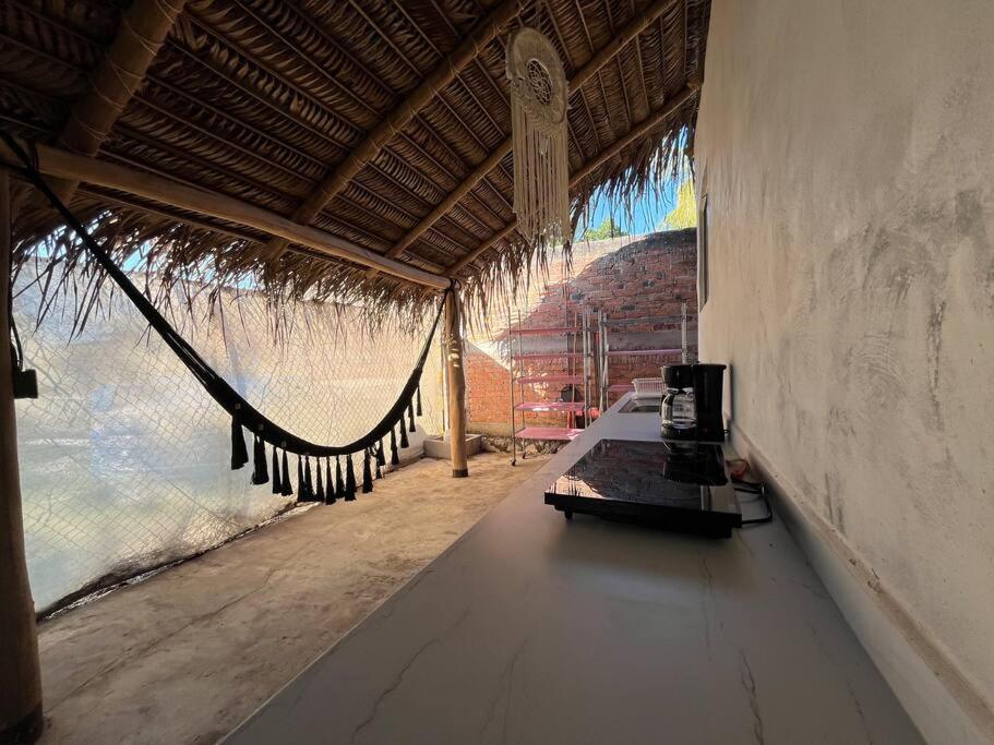 a resort room with a hammock and a view of the ocean at Casa Lorinda in Lo de Marcos