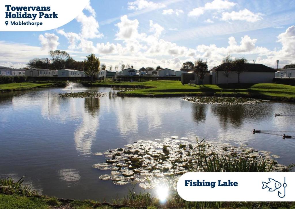 a pond at a golf course with the text fishing lake at Towervans Holiday Park in Mablethorpe