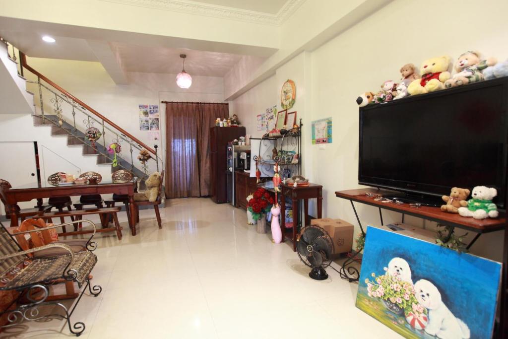 a living room with a large flat screen tv at Beauty Home Homestay in Hualien City