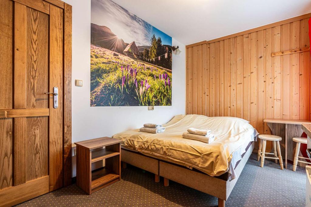 um quarto com uma cama e uma parede de madeira em Willa Baja 2 em Zakopane