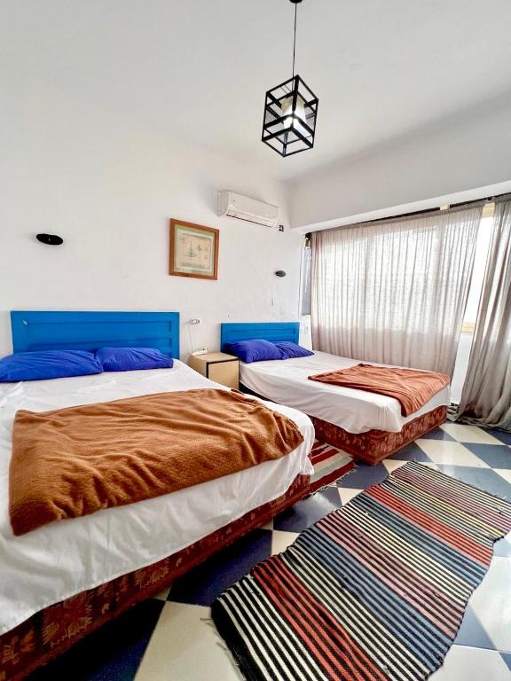 Postel nebo postele na pokoji v ubytování Dahab Vibes Hotel