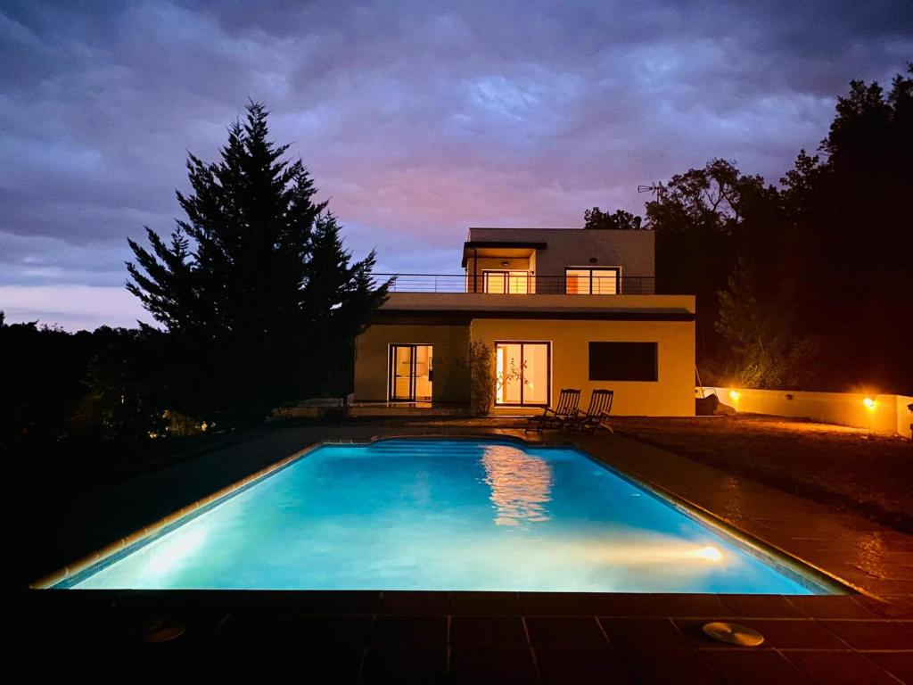 a large swimming pool in front of a house at Casa Caldes de Malavella, 4 dormitorios, 8 personas - ES-209-82 in Caldes de Malavella