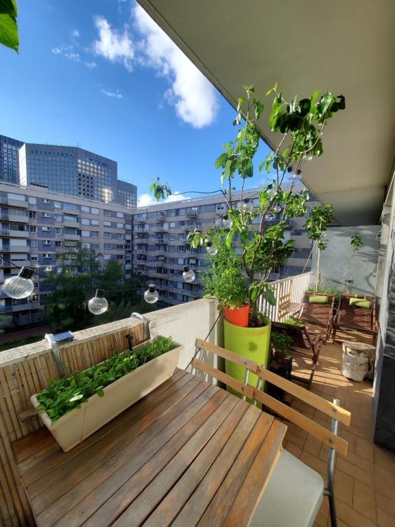 a balcony with a bench and a view of a city at Orangerie de la Défense in Puteaux
