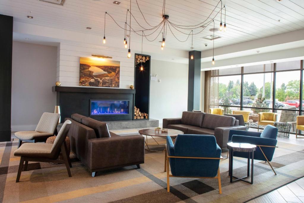 a lobby with couches and chairs and a fireplace at SpringHill Suites by Marriott Great Falls in Great Falls