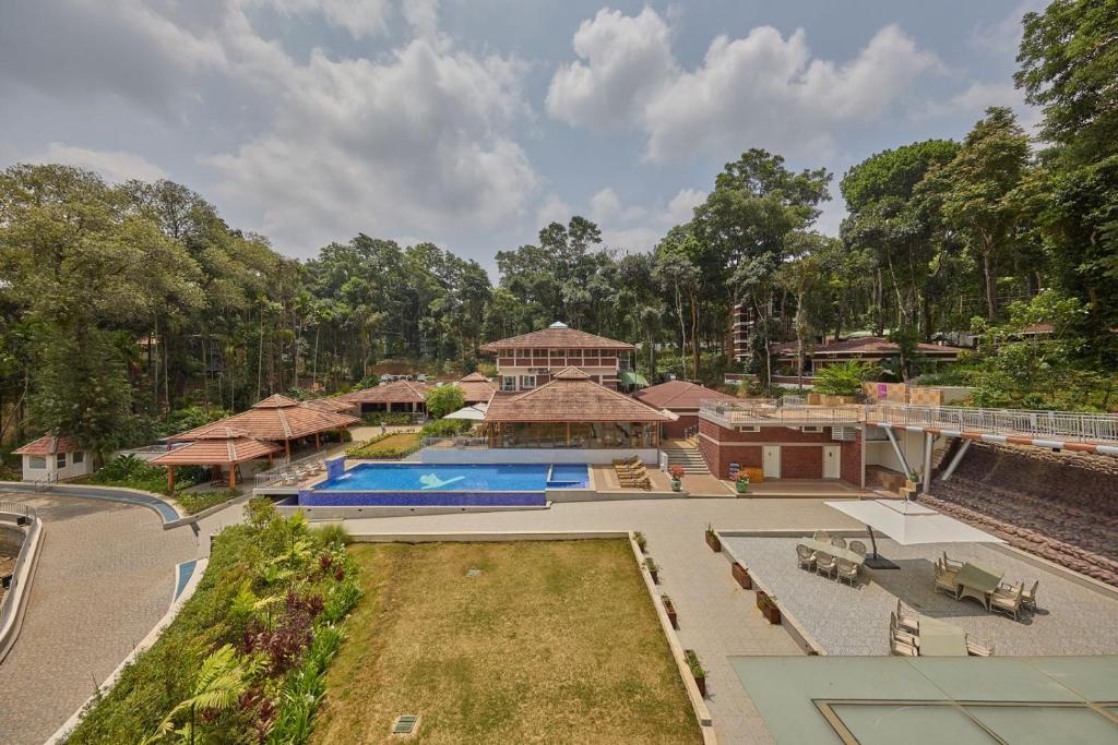 an aerial view of a house with a swimming pool at Regenta Resort Sakleshpur in Sakleshpur