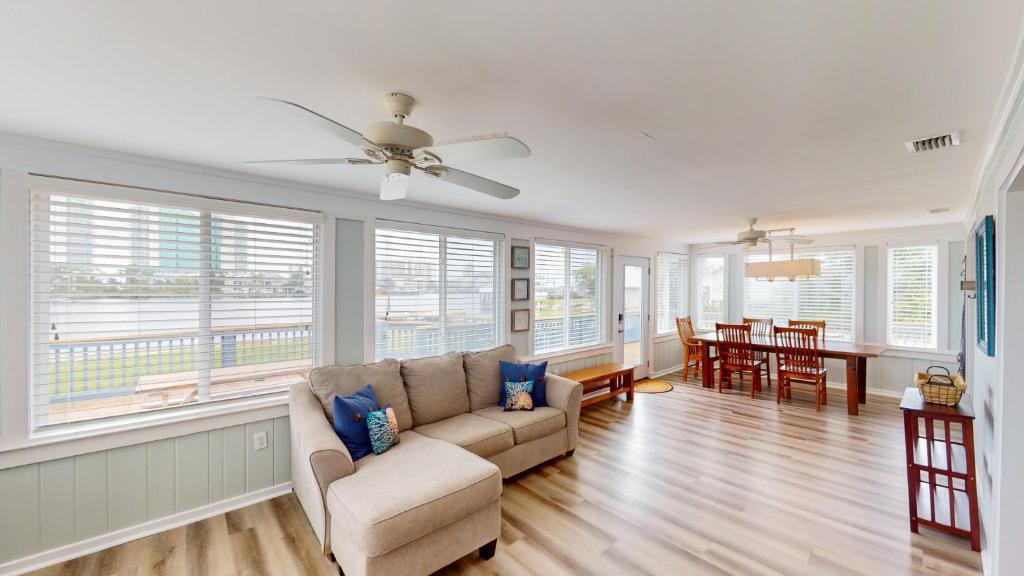 a living room with a couch and a table at Recently Updated Home w/ Private Pier/Boat Slip in Orange Beach